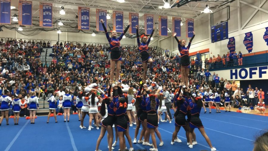 HEHS cheerleaders perform for students and staff at the Homecoming Kick-Off Assembly.