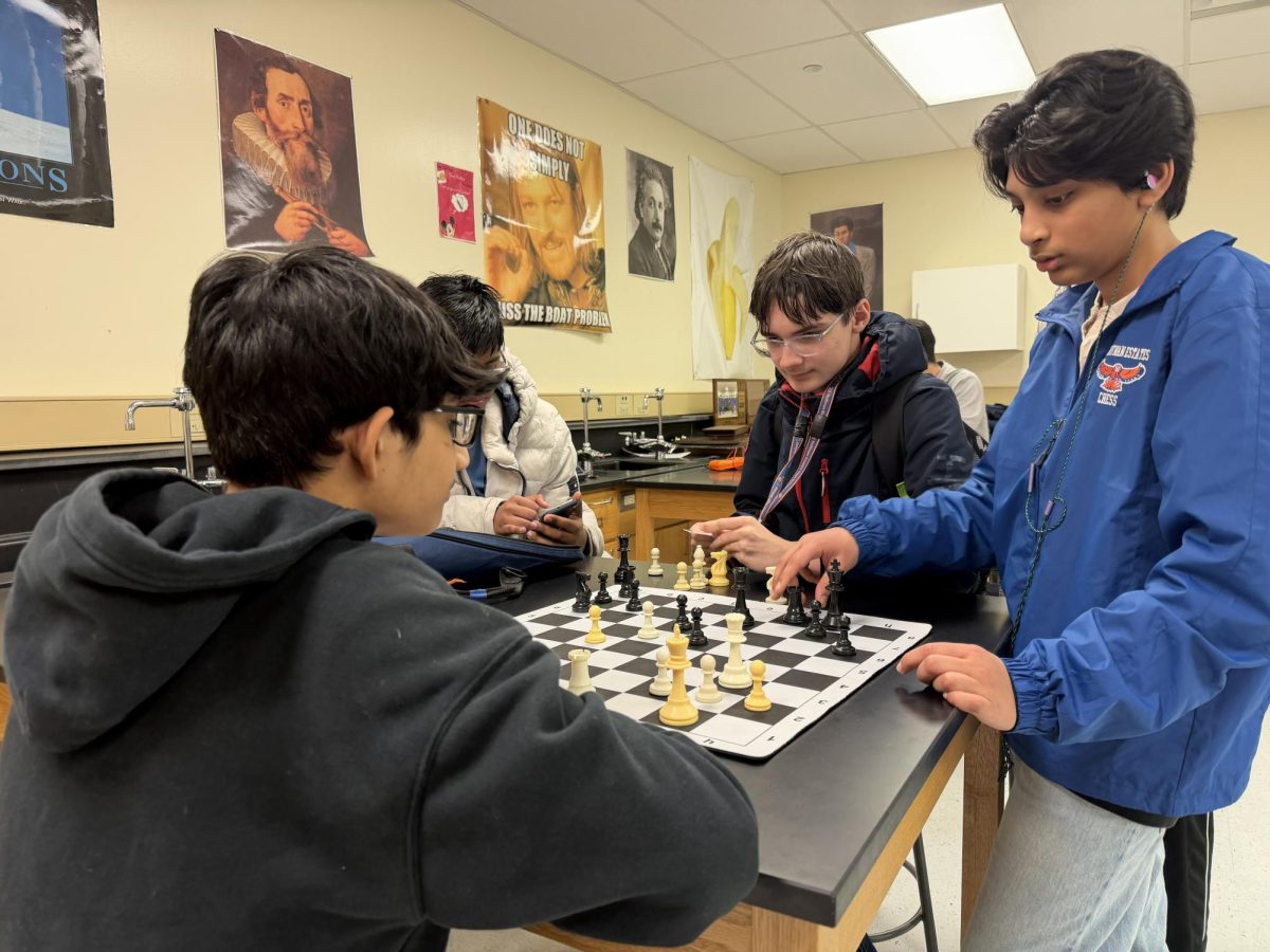 Rudransh Kumar, Matthew Bonness, and Ibrahim Uddin practice the art of chess.
